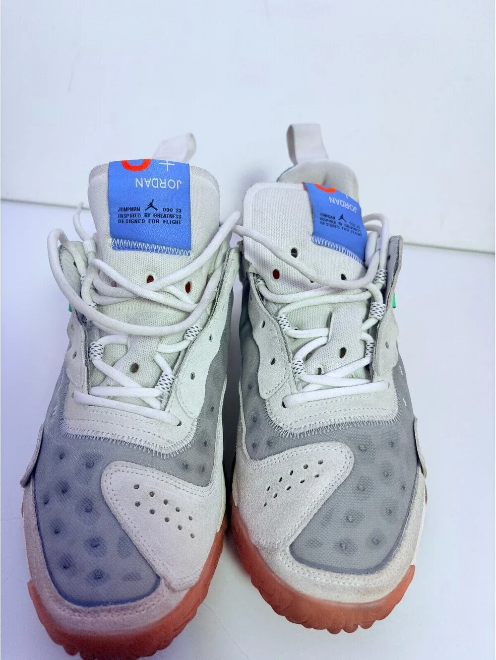 Jordan React white gray sneakers with orange outsole